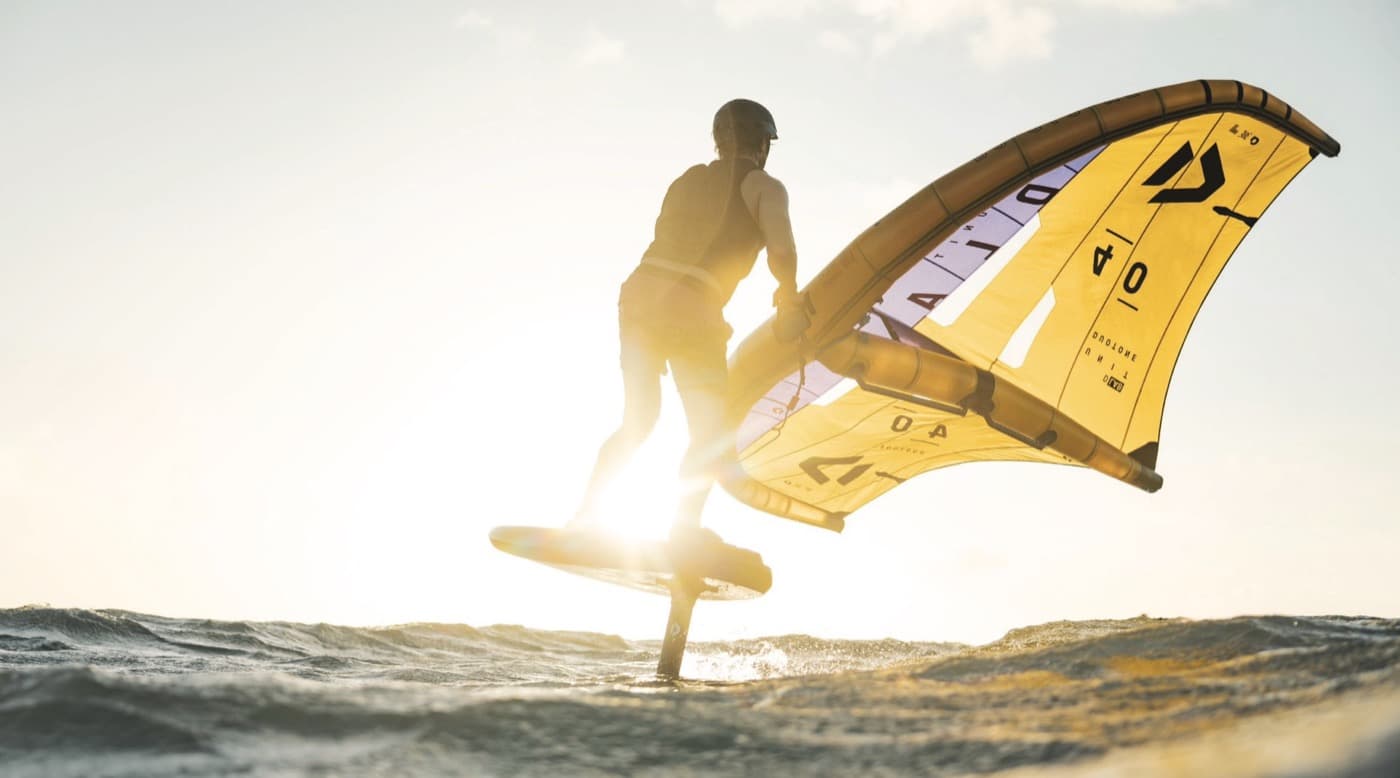 Wing foiler riding into the sun in Brazil