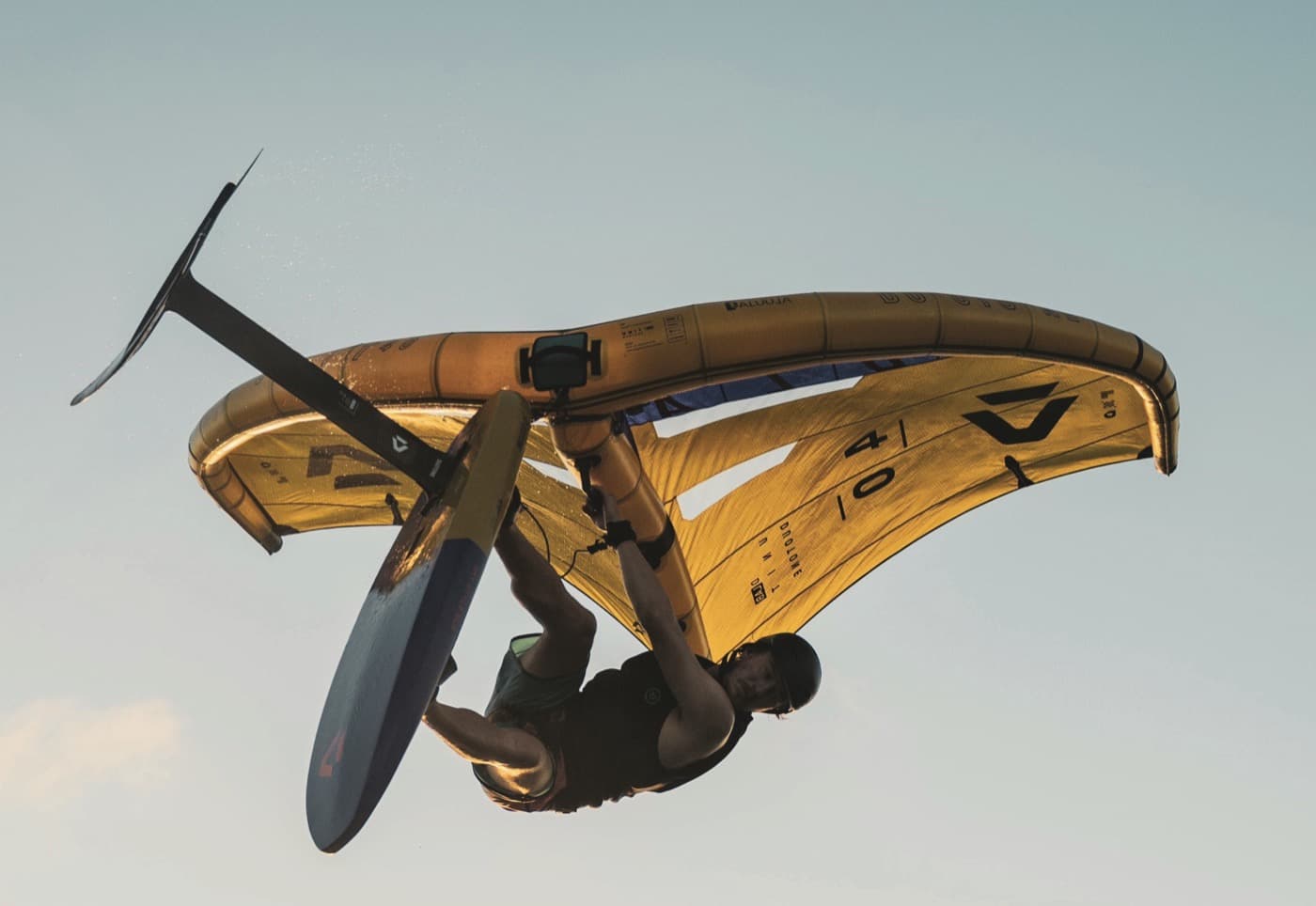 Rider upside down under a yellow Duotone wing in Brazil