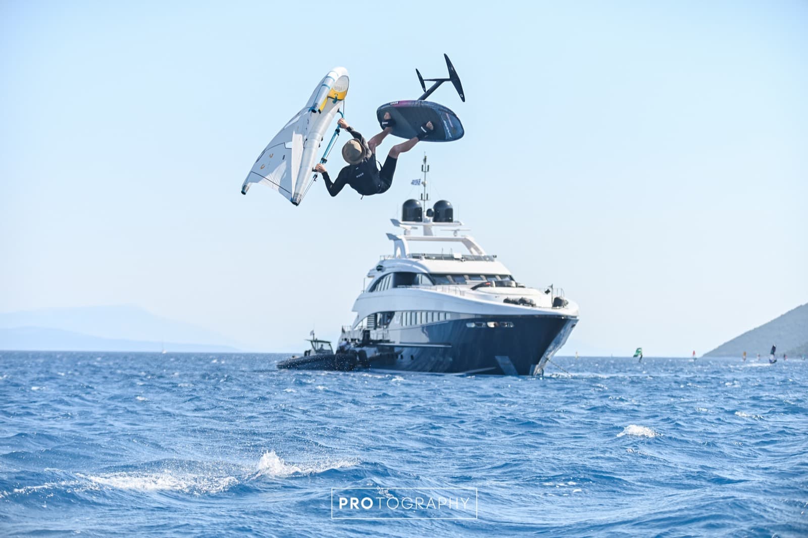 Toby jumping over a superyacht in Vassiliki Bay
